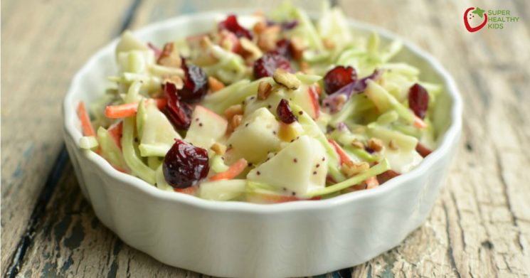 broccoli apple salad with a poppyseed dressing in a small serving dish