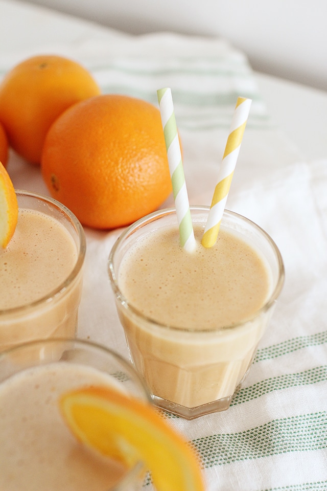 Serve up a fresh glass of vitamin C, protein, and real fruit with this healthy Orange Julius recipe made from simple whole food ingredients. orange julius recipe in glasses with fresh oranges