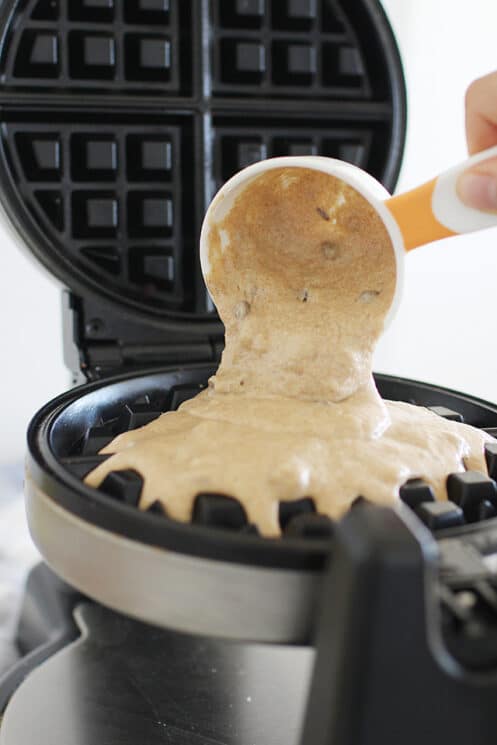 pouring batter on a waffle iron