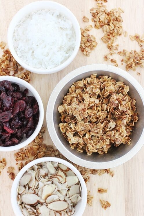 bowls of coconut, cranberries, almonds, and homemade granola