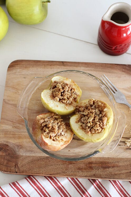 baked apples in a dish with oat topping