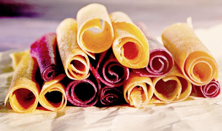 homemade fruit roll-ups stacked on top of each other looking at the rolls