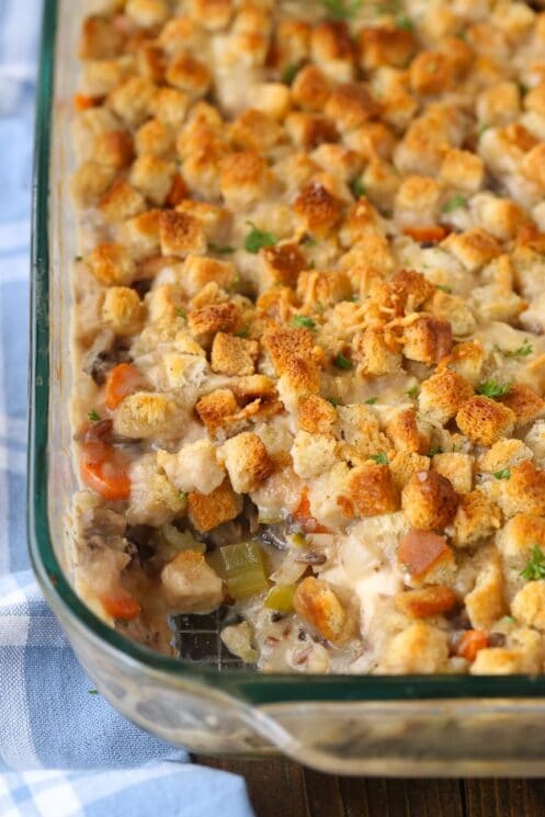 chicken wild rice casserole topped with bread cubes in a clear serving dish