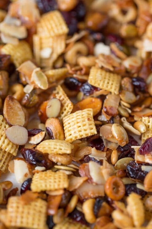 snack mix with cereal squares, dried cranberries and nuts