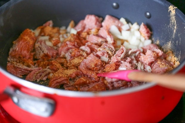 How to make Protein Packed Breakfast Burritos, meat cooking in a pan with onions and spices