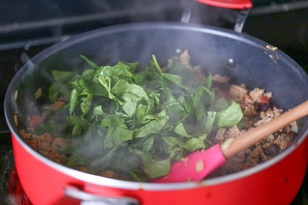 How to make Protein Packed Breakfast Burritos with spinach, meat cooking in a pan with spinach