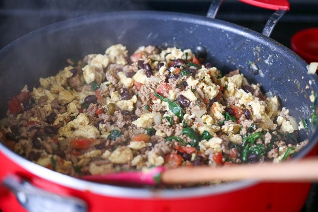 How to make Protein Packed Breakfast Burritos, meat, eggs, beans, spinach, tomato, onion cooking