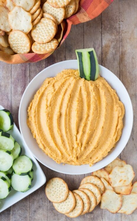 Pumpkin Hummus for Kids with cucumbers and crackers.