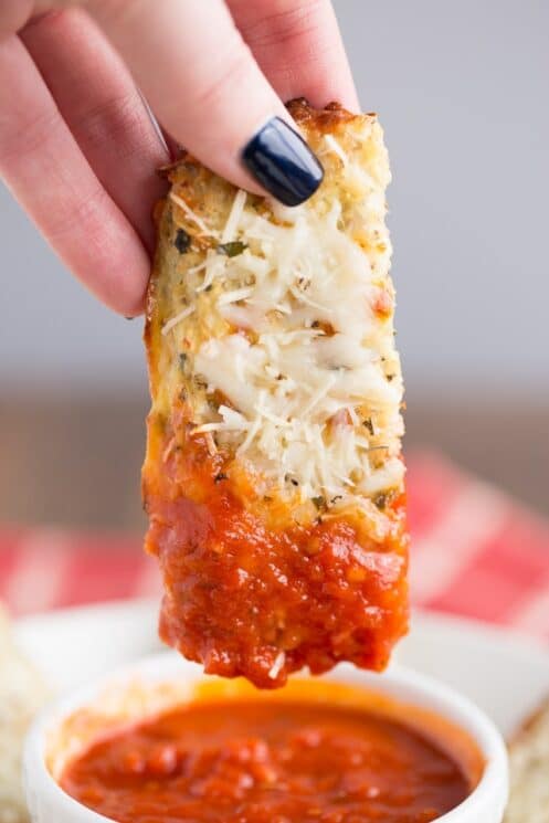 Cheesy Cauliflower Breadsticks Recipe dipped in marinara sauce