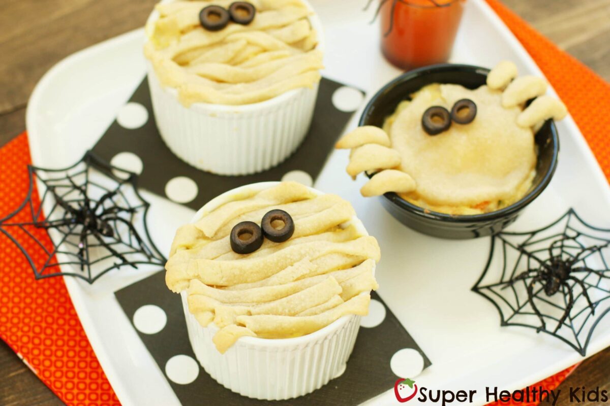 halloween pot pies decorated like spiders and mummies
