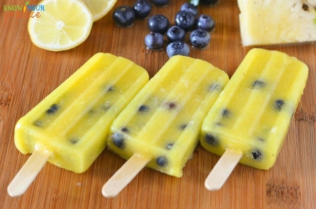 Pineapple Lemonade Ice Pops with Blueberries. Super refreshing with an amazing flavor! www.superhealthykids.com