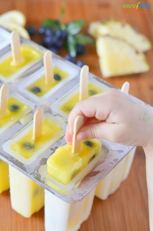 Pineapple Lemonade Ice Pops with Blueberries. Super refreshing with an amazing flavor! www.superhealthykids.com