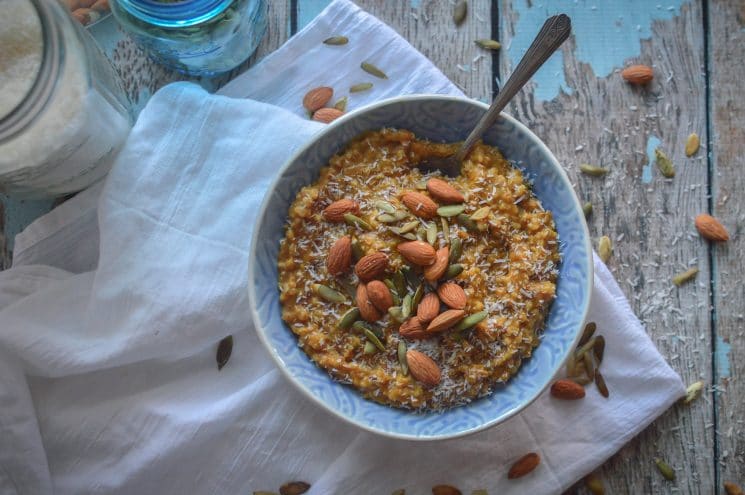 rustic bowl of oatmeal with nuts and seeds on top