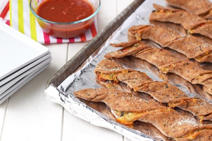 Veggie Stuffed Pizza Twists - The funnest way to eat vegetables ever! Whole wheat pizza crust stuffed with veggies and cheese and dipped in pizza sauce. Kids will love this healthy dinner!