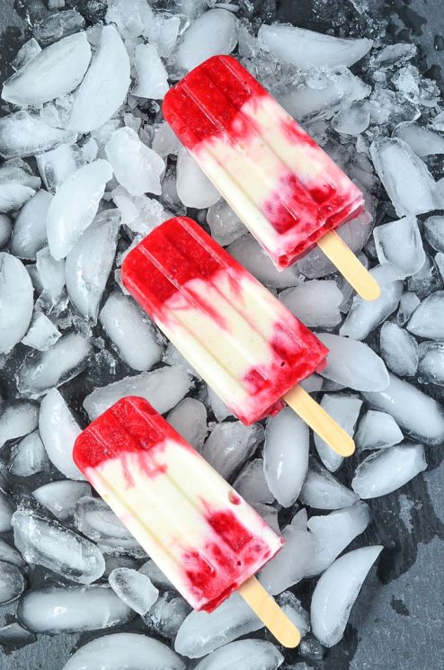 Creamy Raspberry Lemonade Popsicles. Sweet vanilla bean mixed with tart raspberry and lemon. www.superhealthykids.com