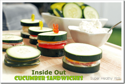 cucumber slices used as the bread for mini sandwiches with ham and cheese with decorative picks