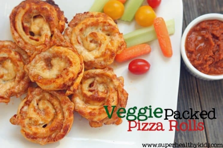 pizza rolls on a white plate served with fresh veggies