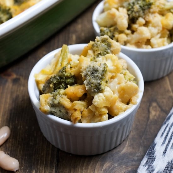 small white bowls filled with cheesy broccoli and cauliflower casserole