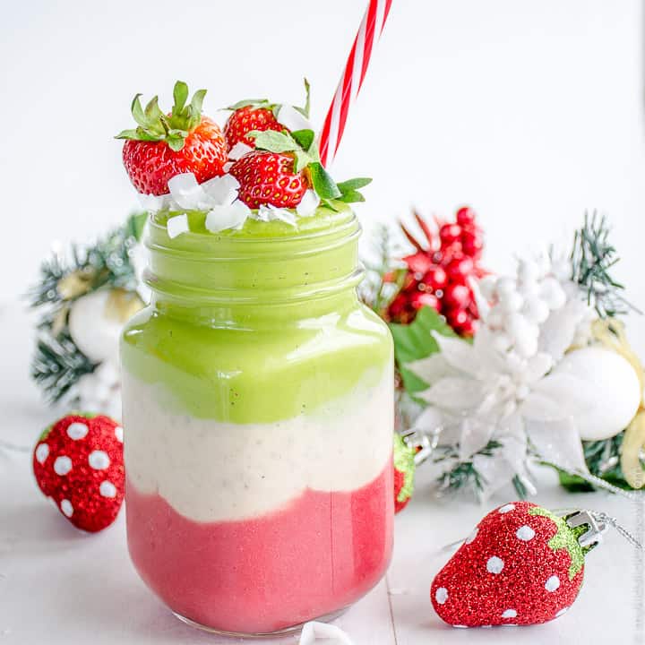 Jar Mug with a green, white and red layered smoothie topped with strawberries and a red and white straw