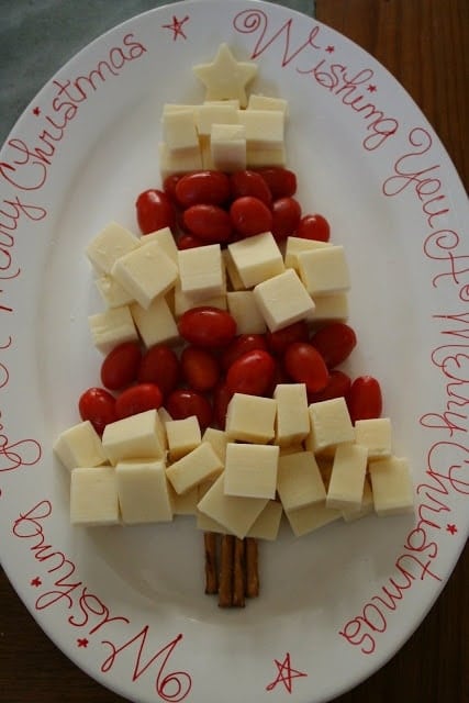 cheese cubes and cherry tomatoes shaped into a christmas tree