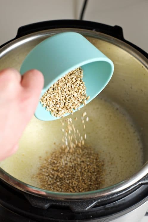 pouring steel cut oats into an instant pot