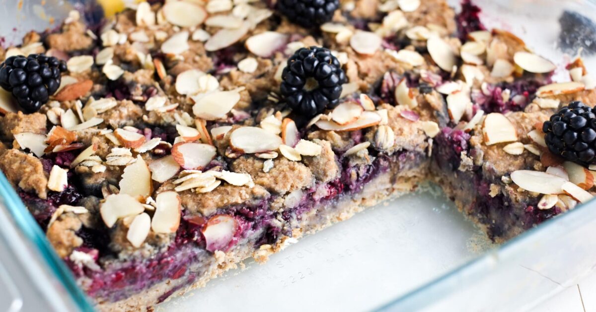 Blackberry breakfast bars with sliced almonds in a glass baking dish
