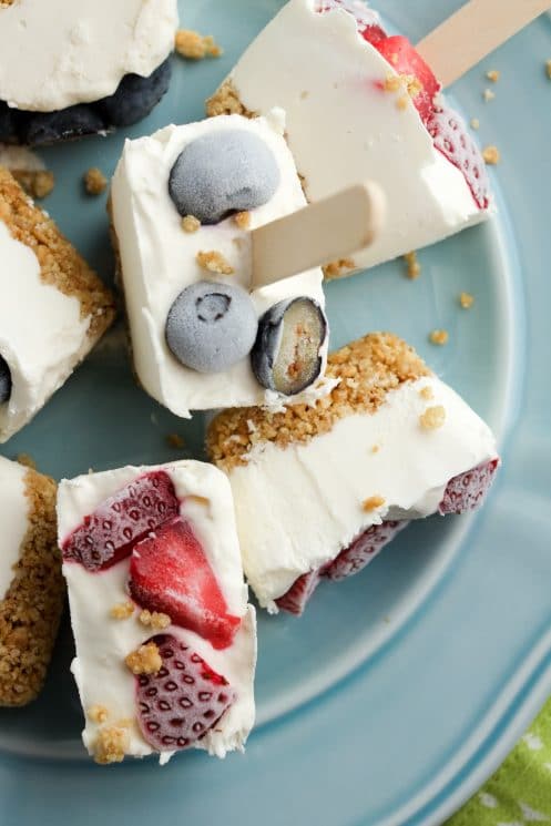 frozen cheesecake bites topped with strawberries and blueberries