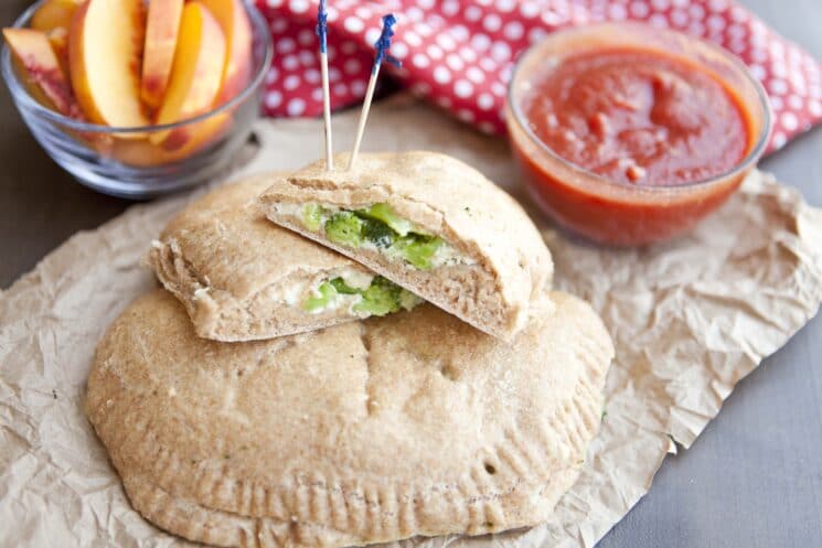 Grab and Go Dinner Ideas! 2 broccoli calzone served on brown paper with marinara dipping sauce