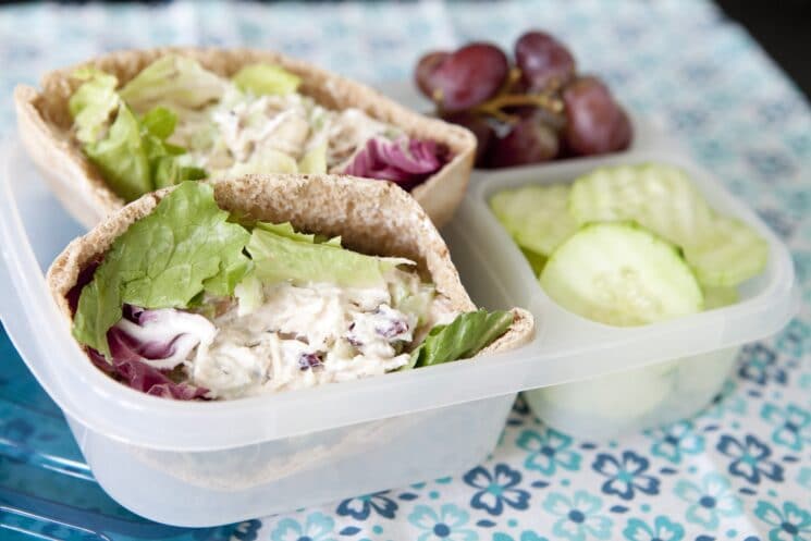 chicken salad pita with cucumbers and grapes in a lunchbox