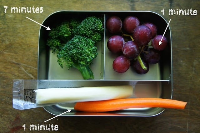 lunchbox with quick fresh fruits and veggies, grapes and cheese and broccoli and carrots