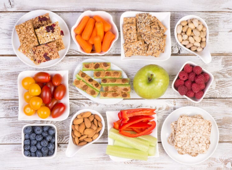 ideas for healthy snacks for kids on white plates on a wooden board