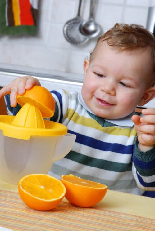 Healthy Snacking for Toddlers, baby juicing oranges