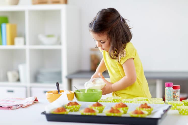 Little girl helping to make muffins