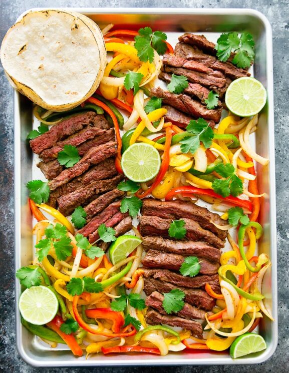 Sheet Pan Steak Fajitas Dinner with peppers and lime and steak