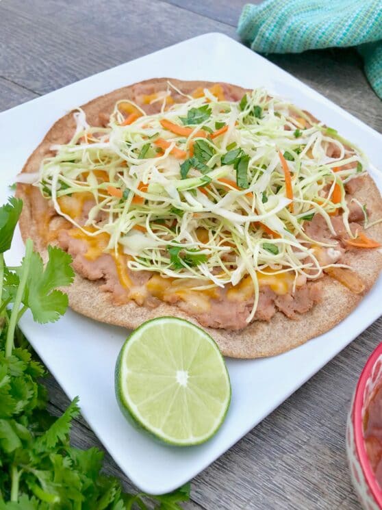 healthy tostada with shredded cabbage and lime