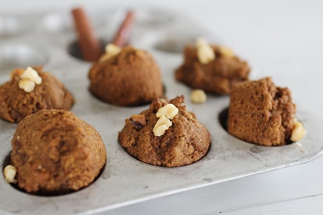 close up view of mini pumpkin molasses muffins in a mini muffin tin