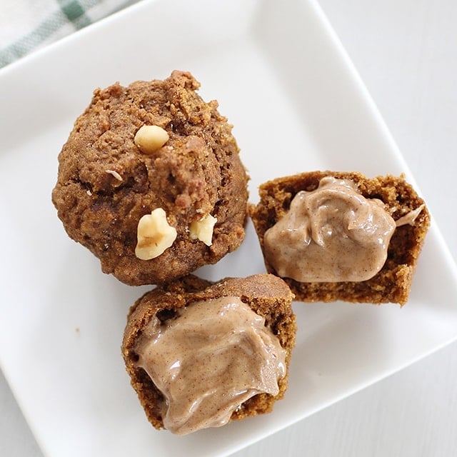 mini pumpkin molasses muffins with almond butter spread on one of them