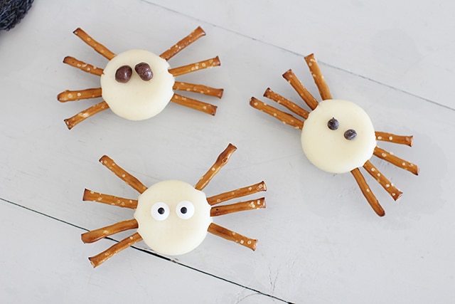spiders made out of cheese rounds and pretzel sticks