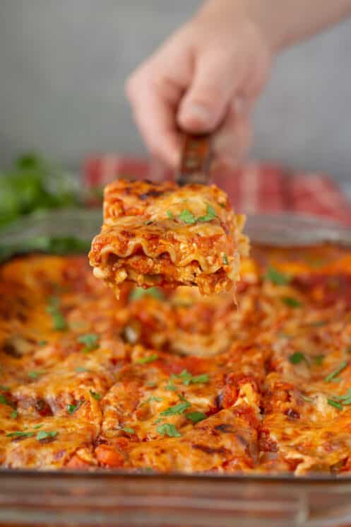 healthy vegetable lasagna slice coming out of the pan