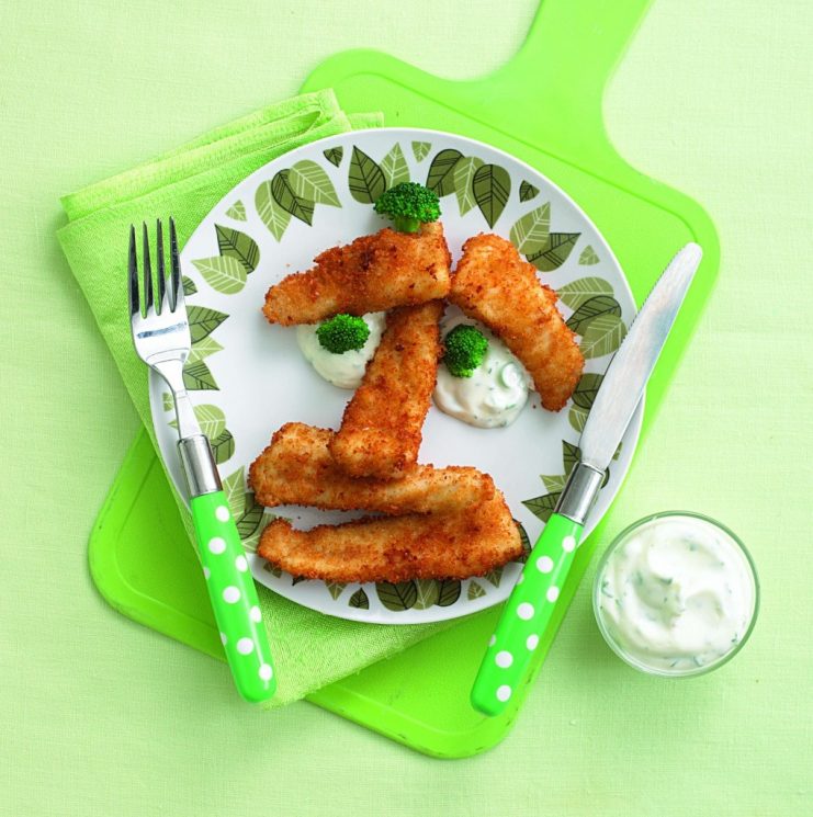 fish sticks in the shape of a face with broccoli