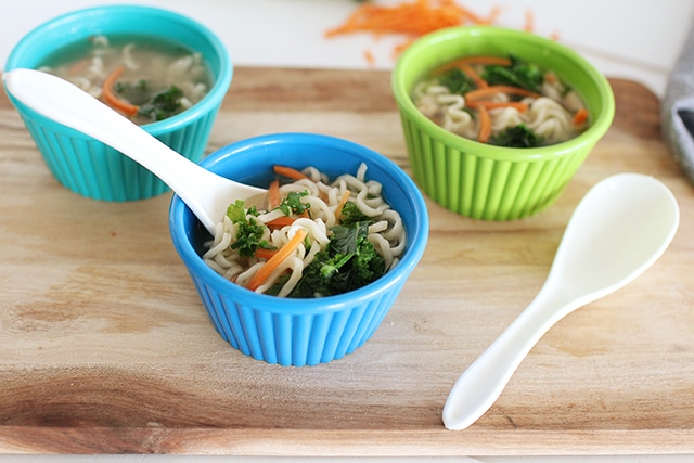 Revamp processed Top Ramen to taste fresher than ever with a gingery broth and loads of fresh mushrooms, carrots, and greens. Make it in minutes in a single pot! small colorful bowls of top ramen with veggies