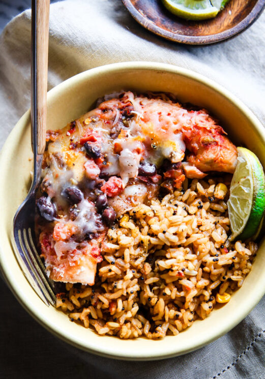healthy bowl of fish, beans, rice and lime