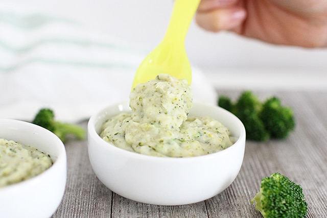 broccoli mashed potatoes in kid bowl with yellow spoon