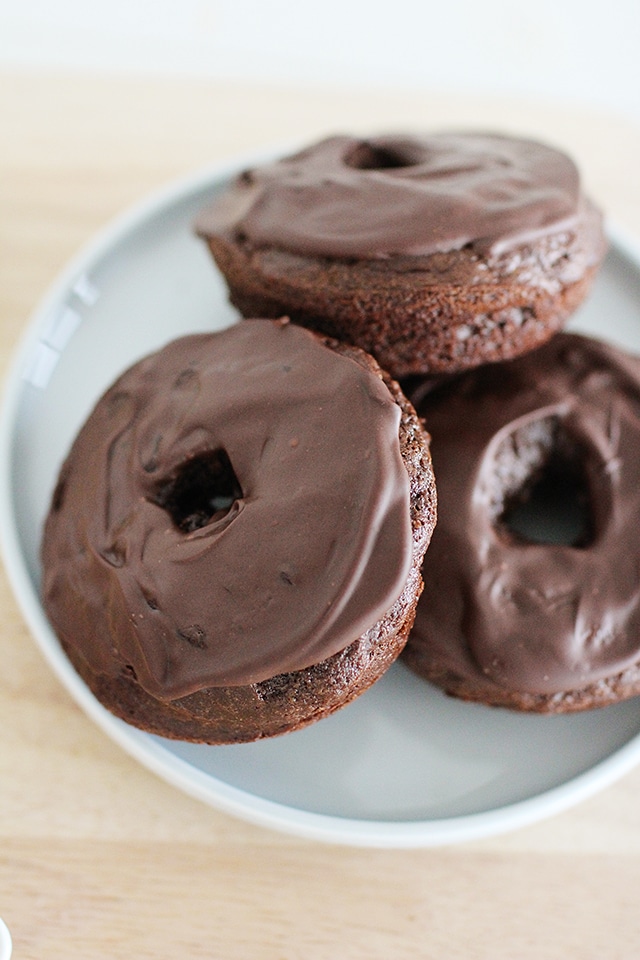 Make rich, chocolatey, homemade donuts right in your own kitchen! These donuts are baked, not fried, and even include a surprise ingredient that makes them a more balanced treat. homemade chocolate donuts