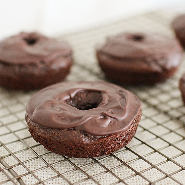 homemade chocolate donuts on cooling rack