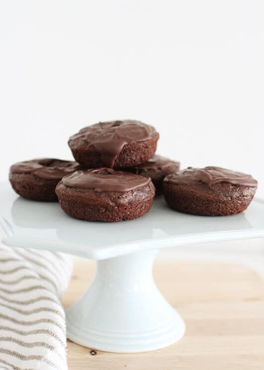 homemade chocolate donuts on a white platter