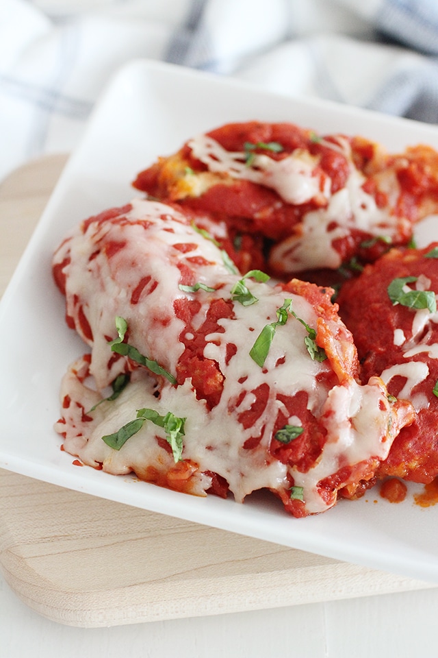 Classic Italian flavor in your Instant Pot! Fall in love with the simplicity of this juicy, tender chicken coated in breading and smothered in a savory tomato sauce and cheese. Chicken parmesan on white plate