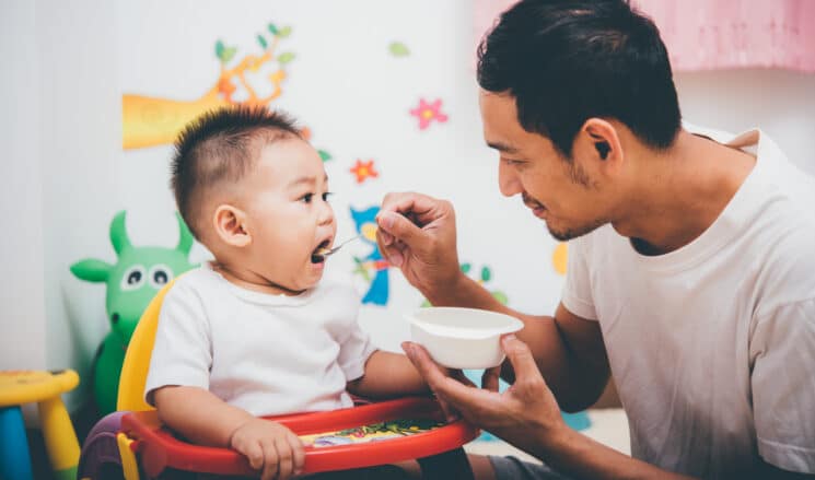 dad feeding his baby