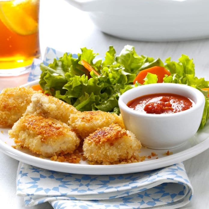 parmesan chicken nuggets on a plate with salad