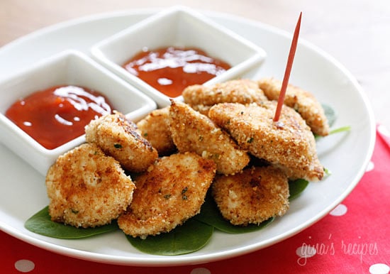 Ditch the frozen nuggets! Try one of these top healthy homemade chicken nugget recipes you can feel proud to serve your kids. baked chicken nuggets with ketchup for dipping